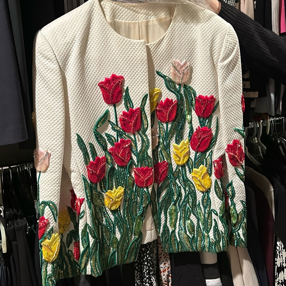 Custom Carolina Herrera jacket with a matching red skirt
